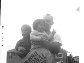 1962 Dad, John, Zann newsp. bag.jpg